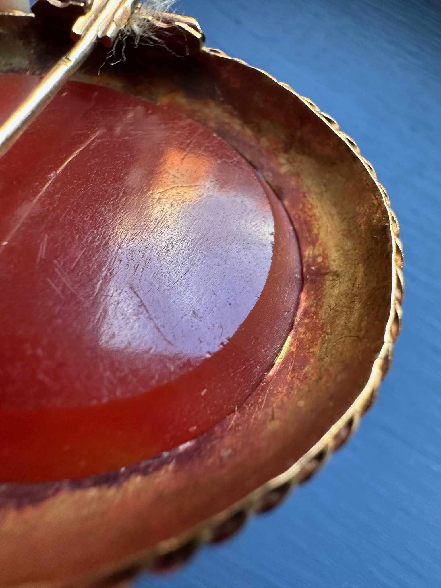 A 19th century gold brooch set with a large carnelian intaglio. Portrait of an Hellenistic ruler.