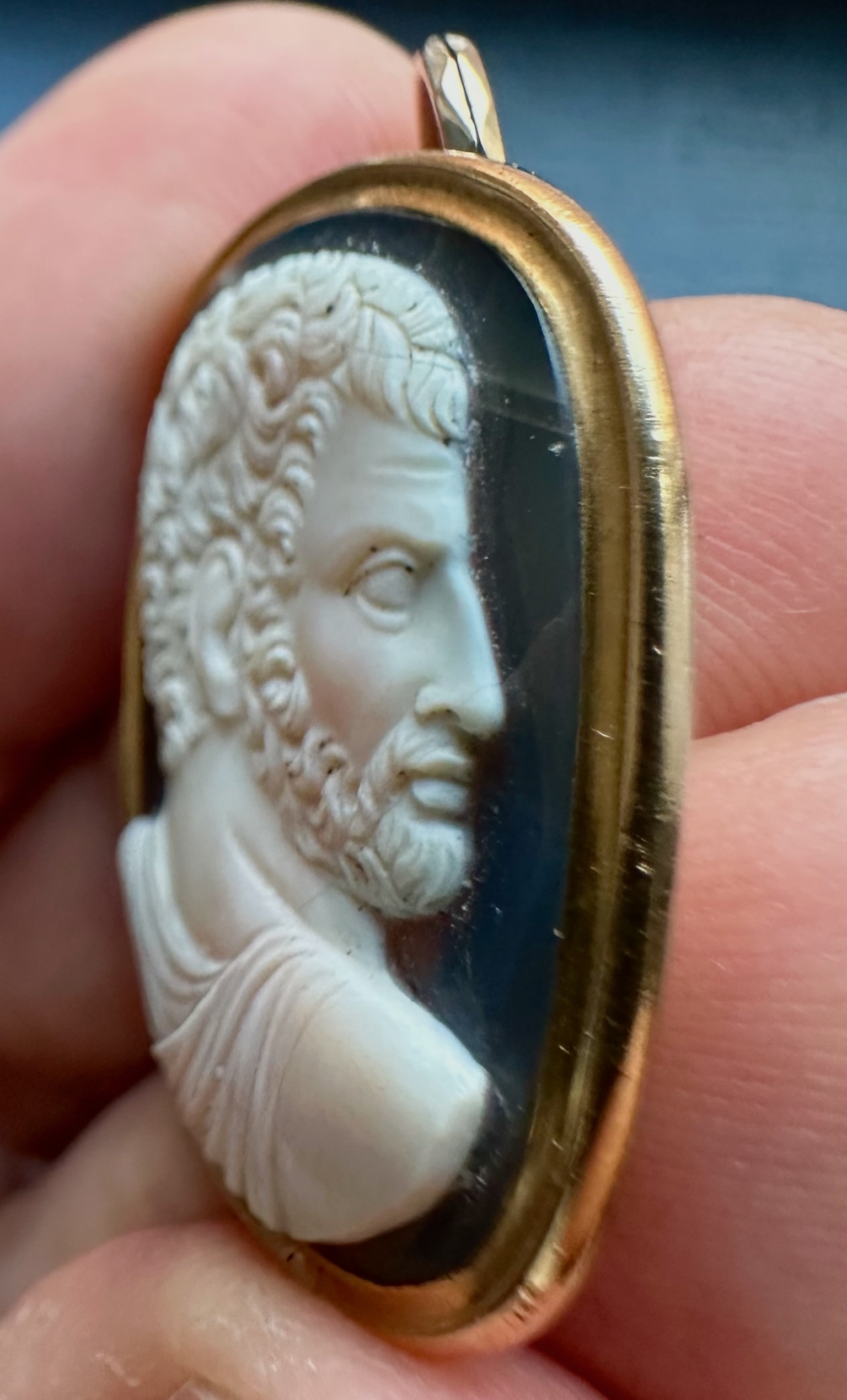 A Grand Tour two-layer agate cameo of a bearded man after the emperor Caracalla, set as a gold pendant.