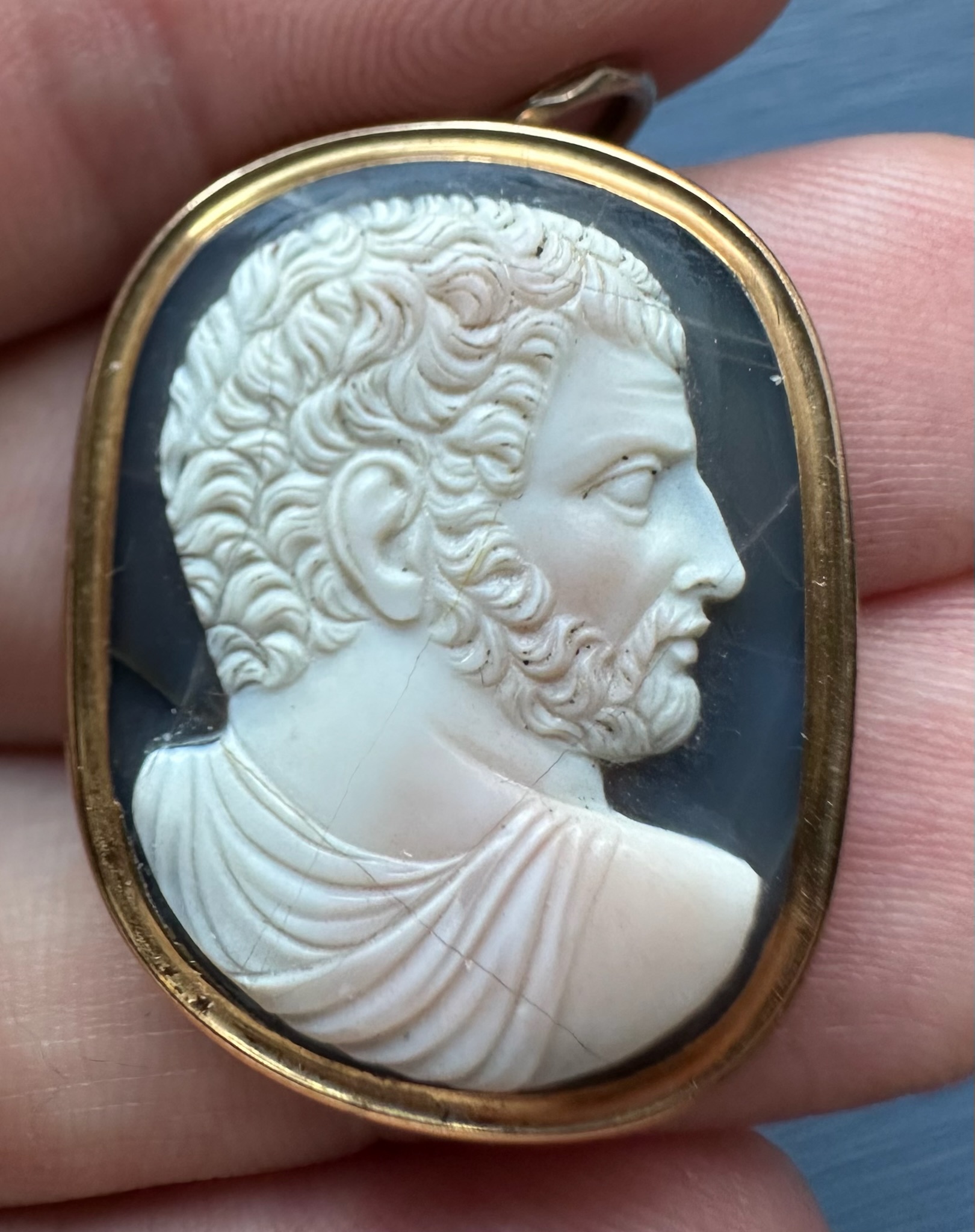 A Grand Tour two-layer agate cameo of a bearded man after the emperor Caracalla, set as a gold pendant.