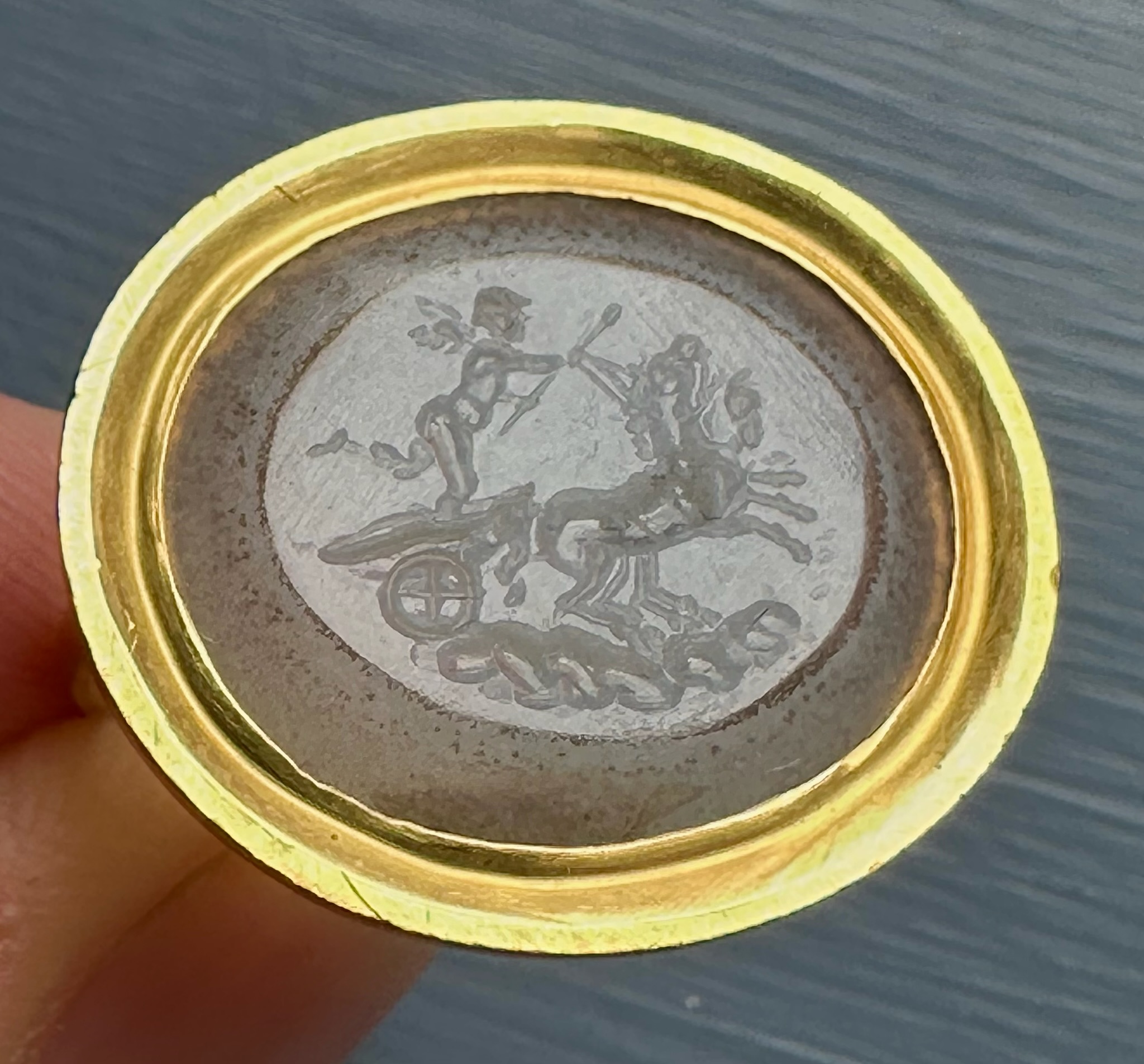 A Neoclassical chalcedony intaglio set in a 22k gold ring. The Conquest of Love.