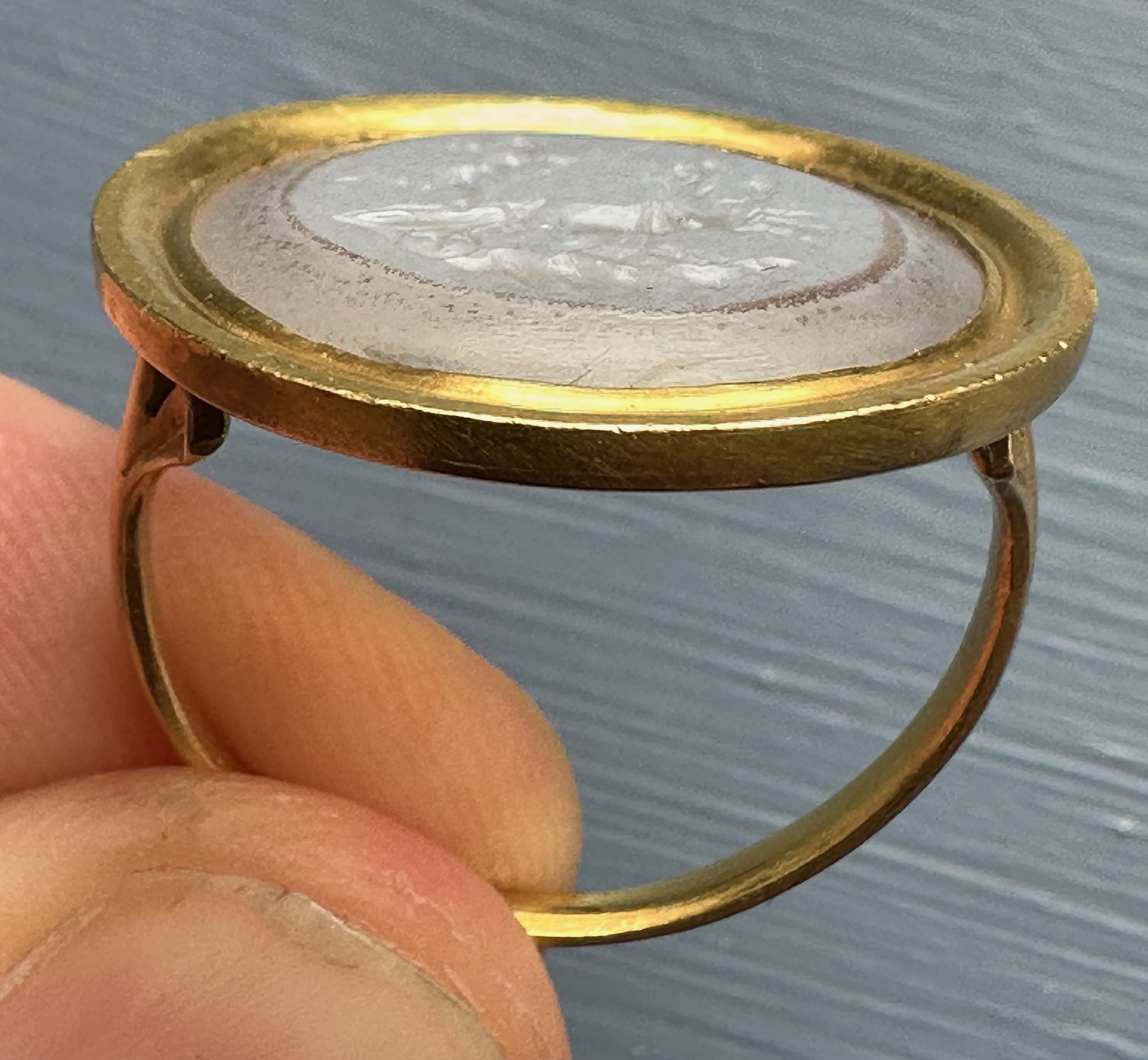 A Neoclassical chalcedony intaglio set in a 22k gold ring. The Conquest of Love.