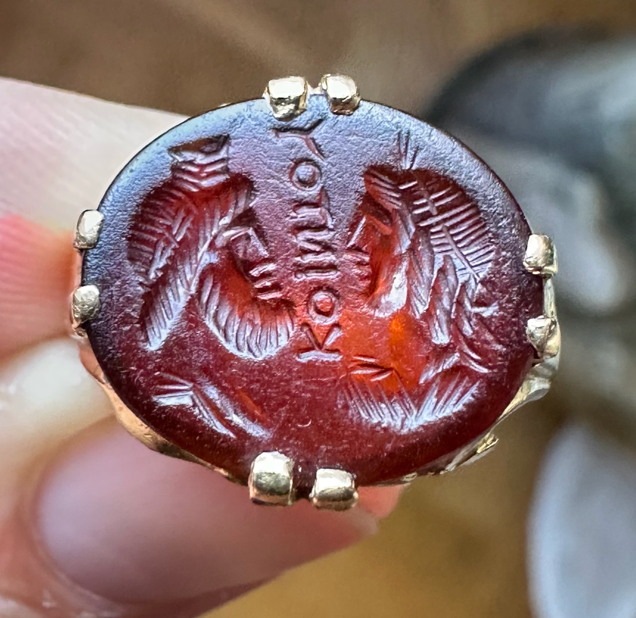 A Late 19th - early 20th c. gold chiseled ring set with a Roman Sard intaglio. Isis and Serapis with inscription.