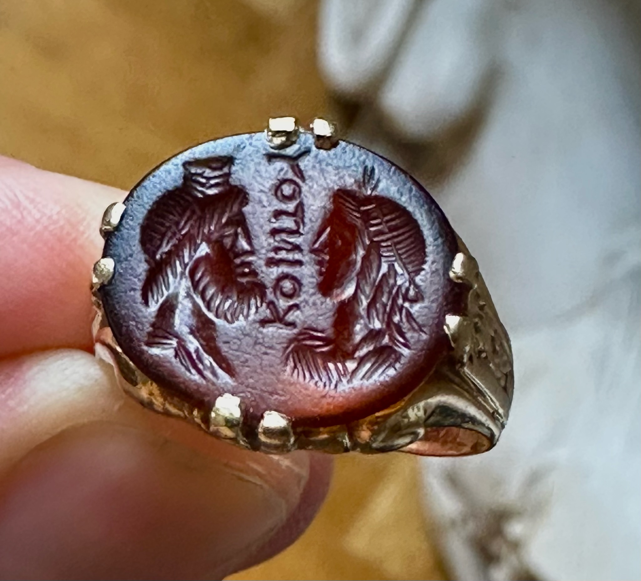 A Late 19th - early 20th c. gold chiseled ring set with a Roman Sard intaglio. Isis and Serapis with inscription.