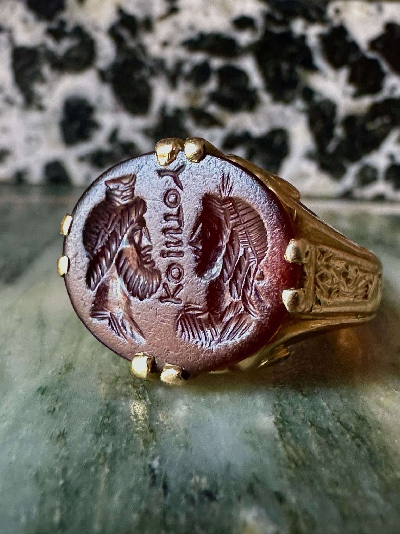 A Late 19th - early 20th c. gold chiseled ring set with a Roman Sard intaglio. Isis and Serapis with inscription.