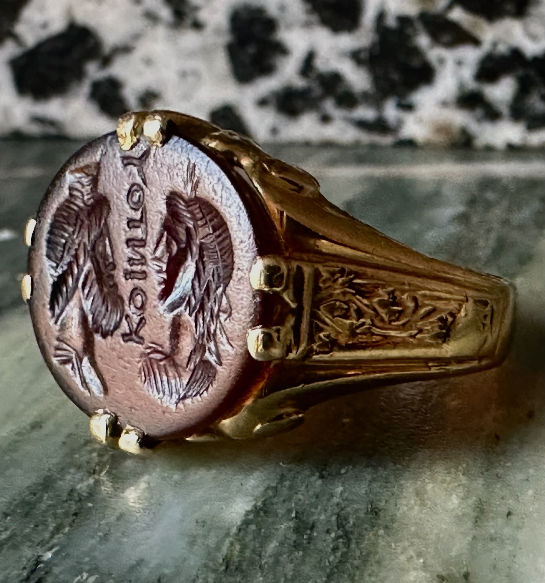 A Late 19th - early 20th c. gold chiseled ring set with a Roman Sard intaglio. Isis and Serapis with inscription.