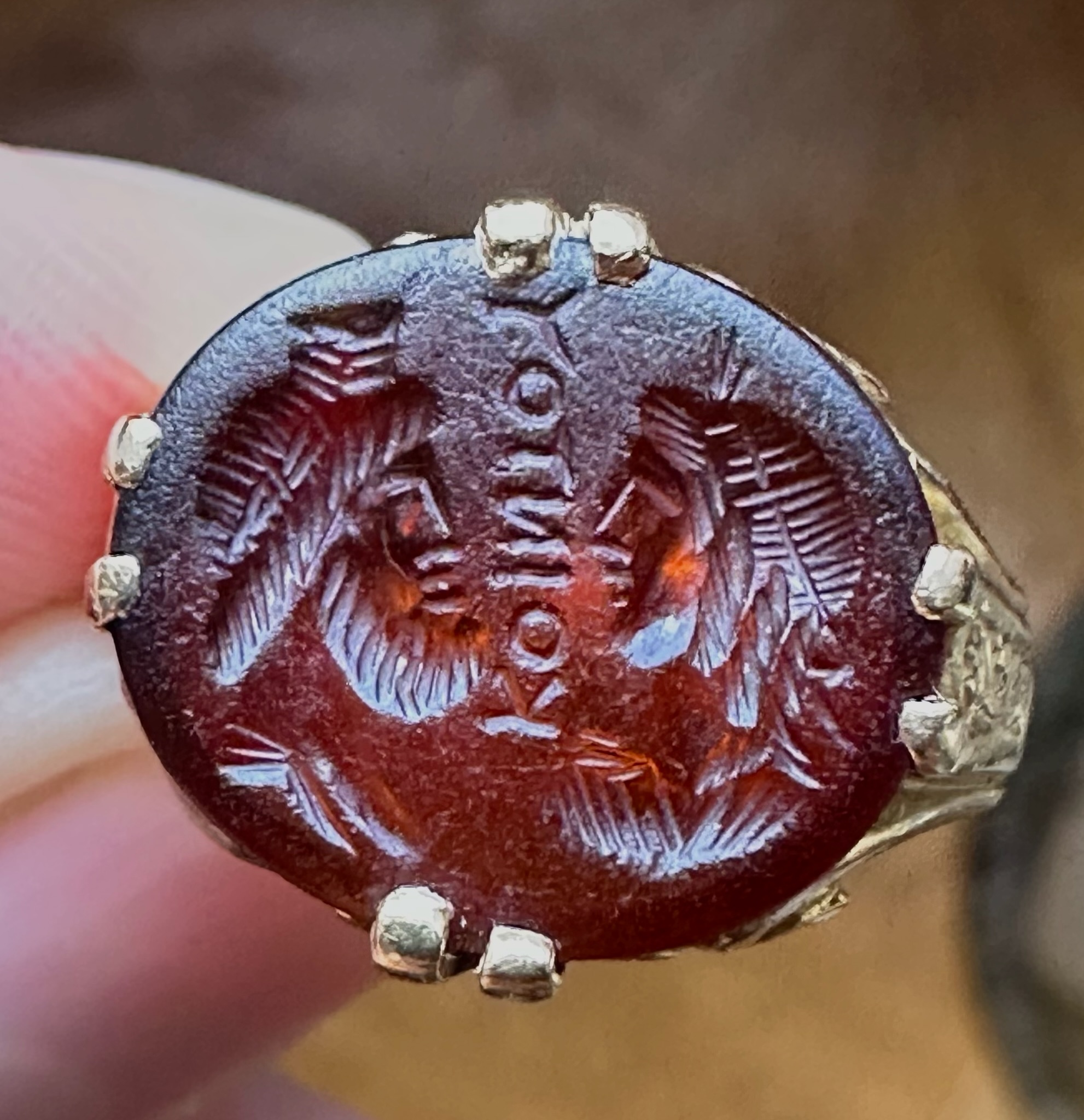 A Late 19th - early 20th c. gold chiseled ring set with a Roman Sard intaglio. Isis and Serapis with inscription.
