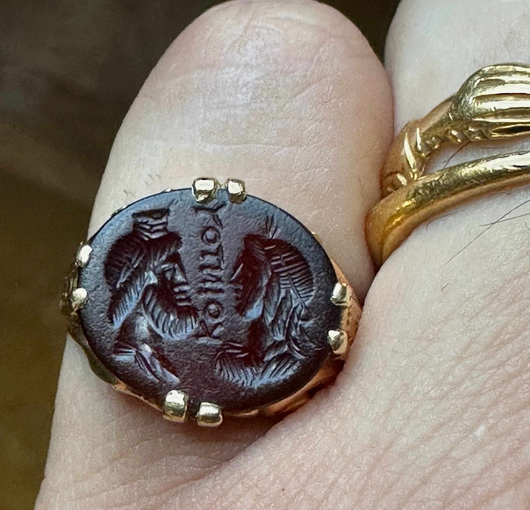 A Late 19th - early 20th c. gold chiseled ring set with a Roman Sard intaglio. Isis and Serapis with inscription.