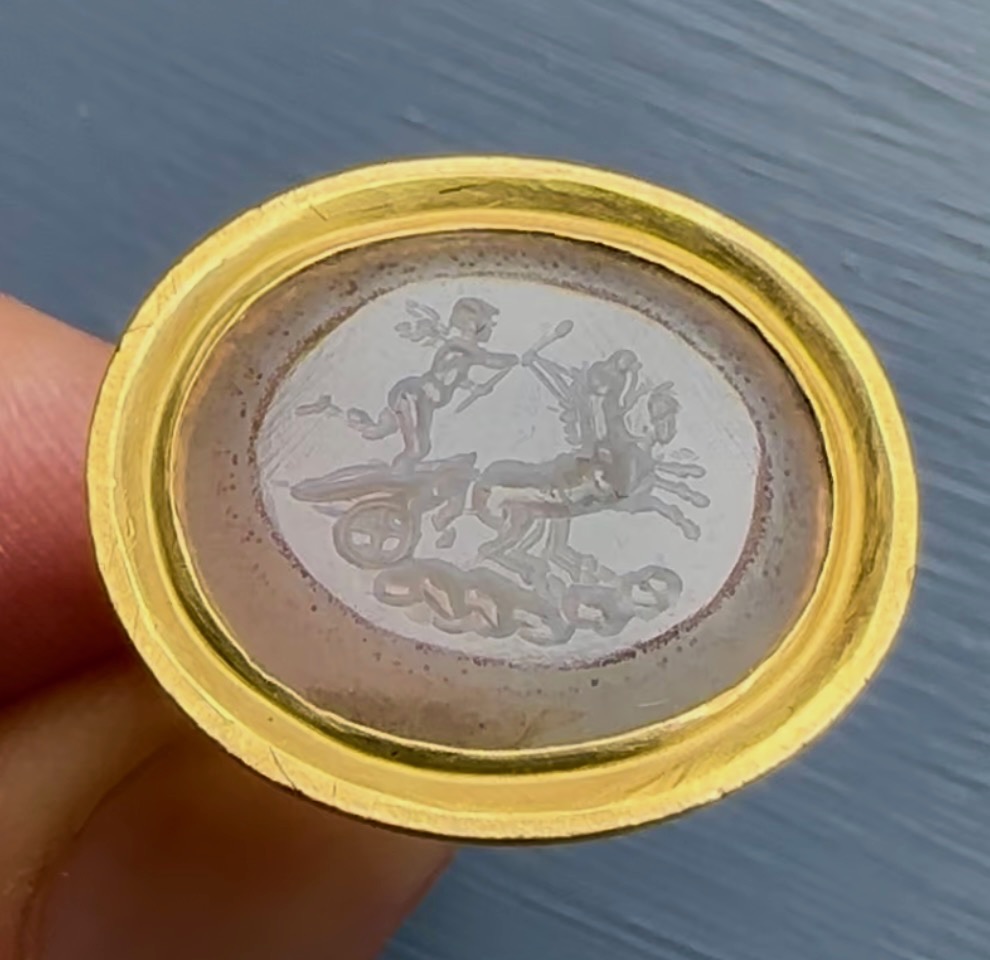 A Neoclassical chalcedony intaglio set in a 22k gold ring. The Conquest of Love.