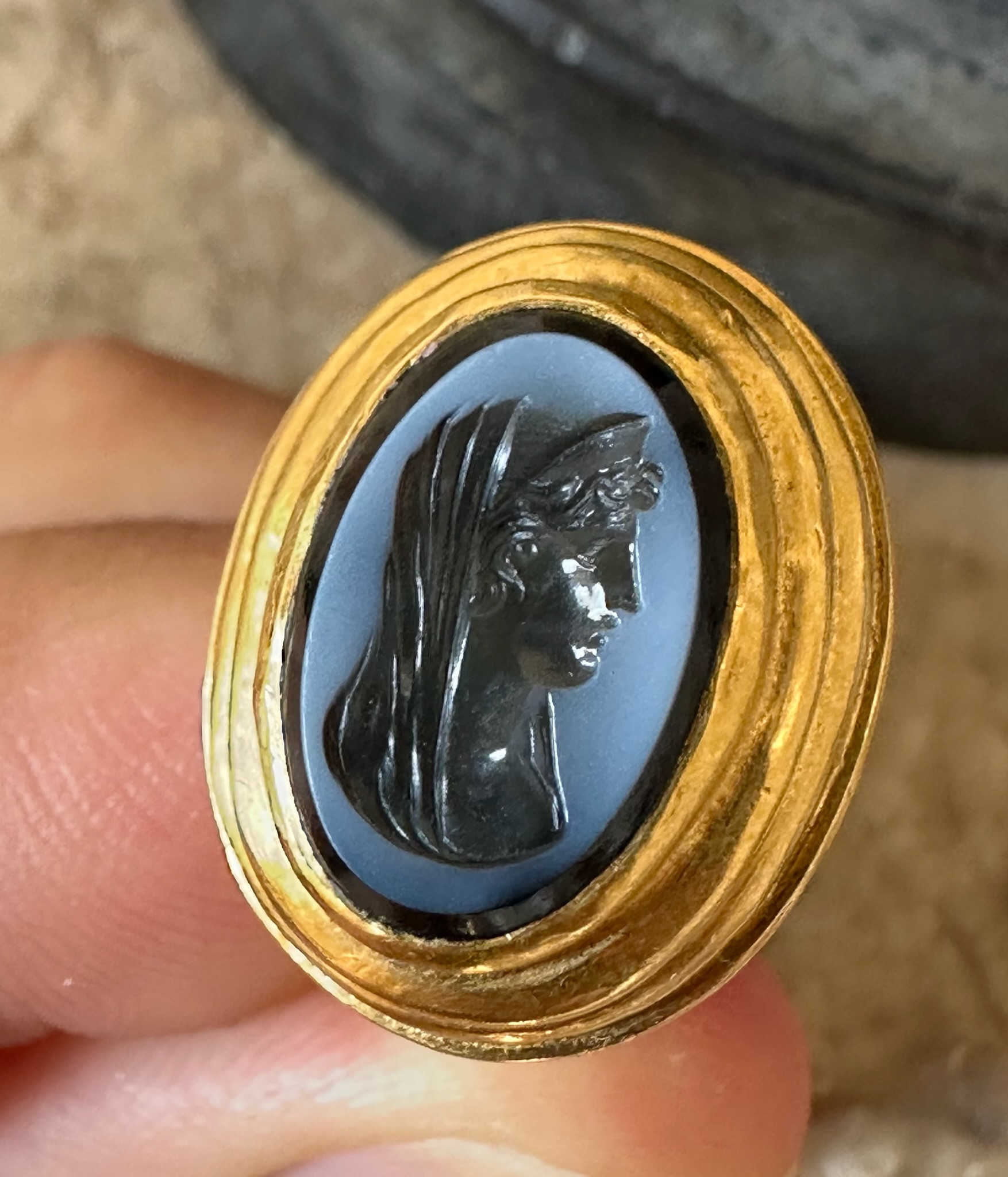A 19th c. massive gold ring set with a nicolo intaglio. Veiled Juno. 