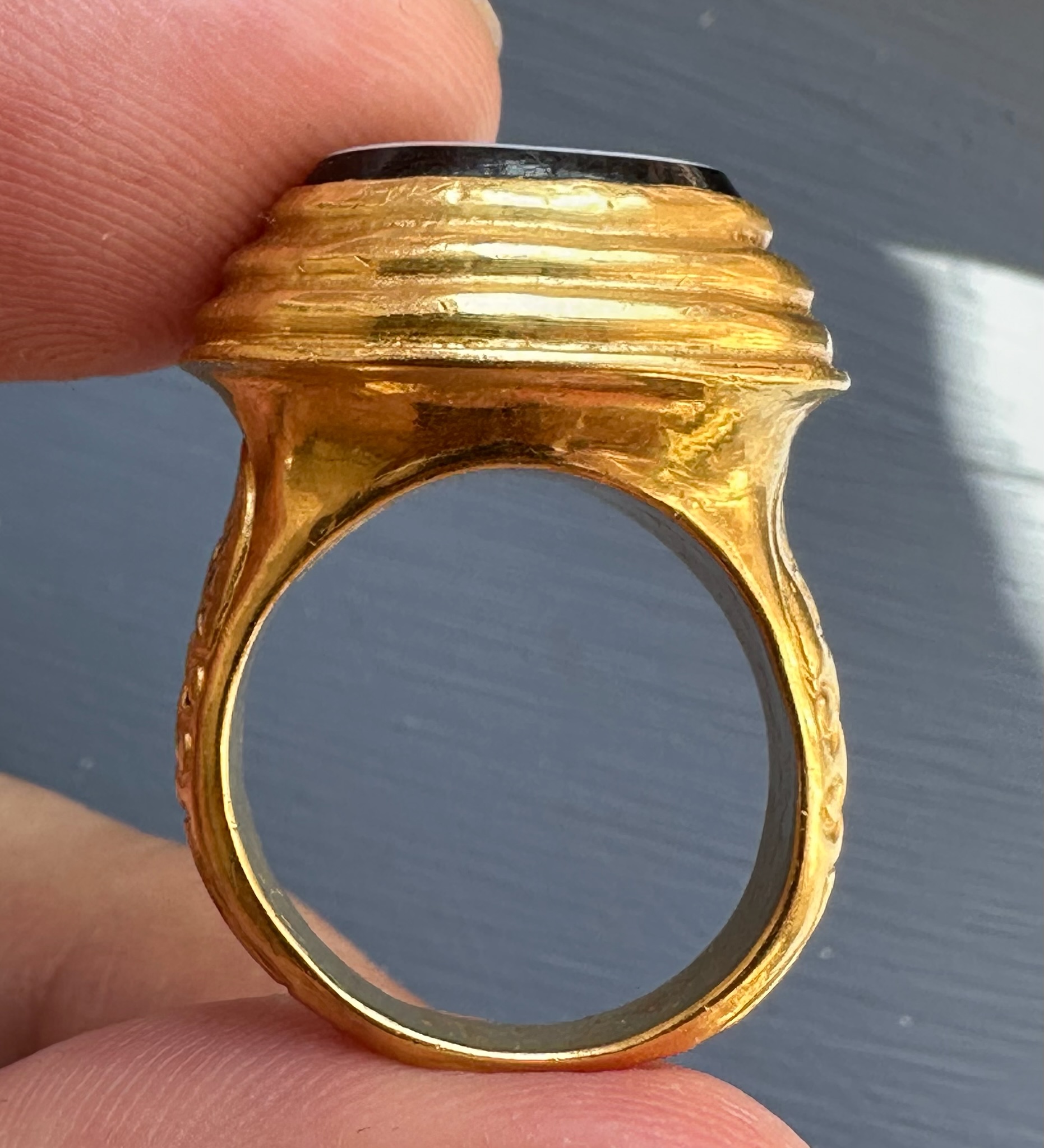 A 19th c. massive gold ring set with a nicolo intaglio. Veiled Juno. 