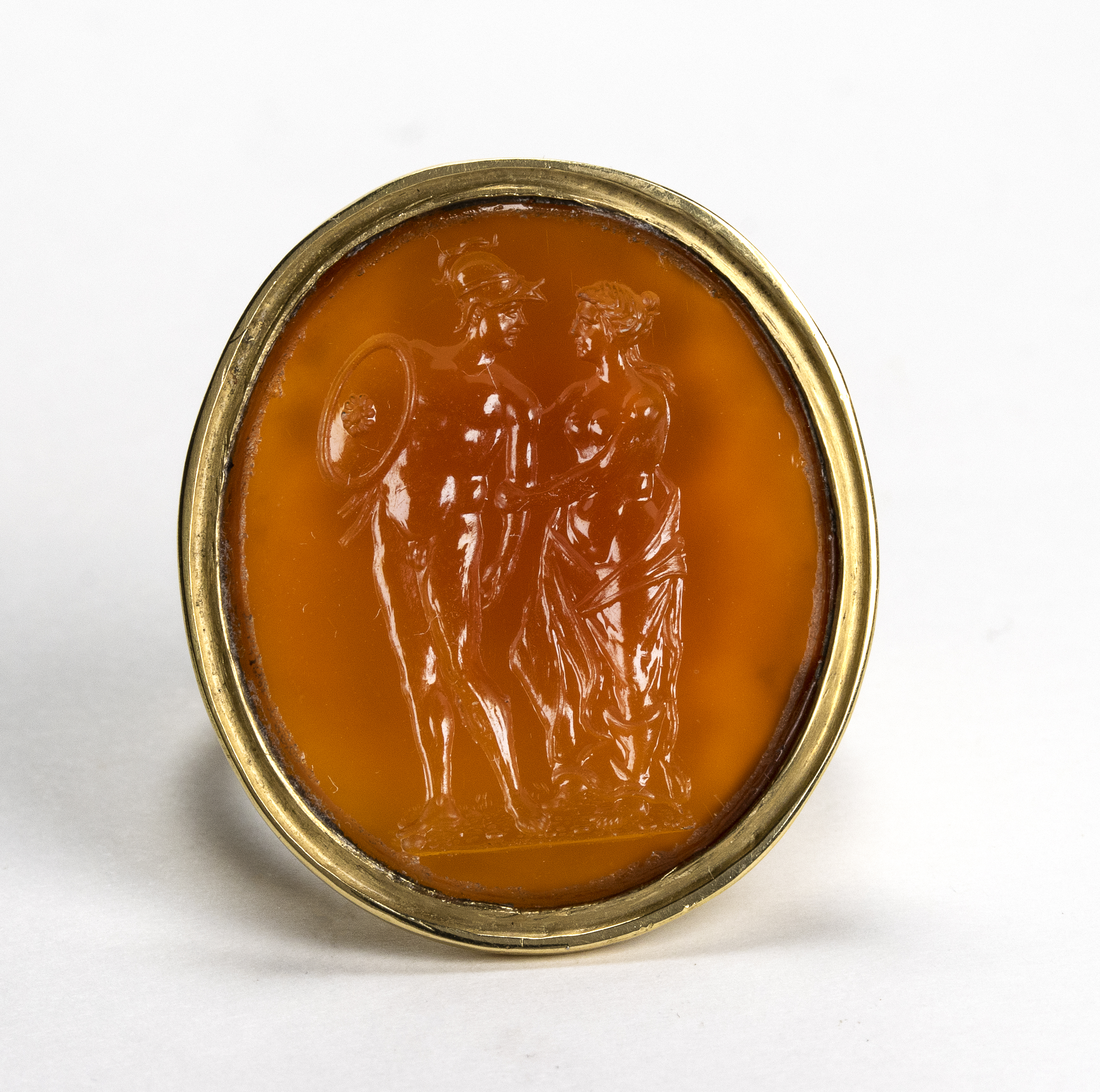 A Large Neoclassical carnelian intaglio set in a later massive gold ring. Mars and Venus.