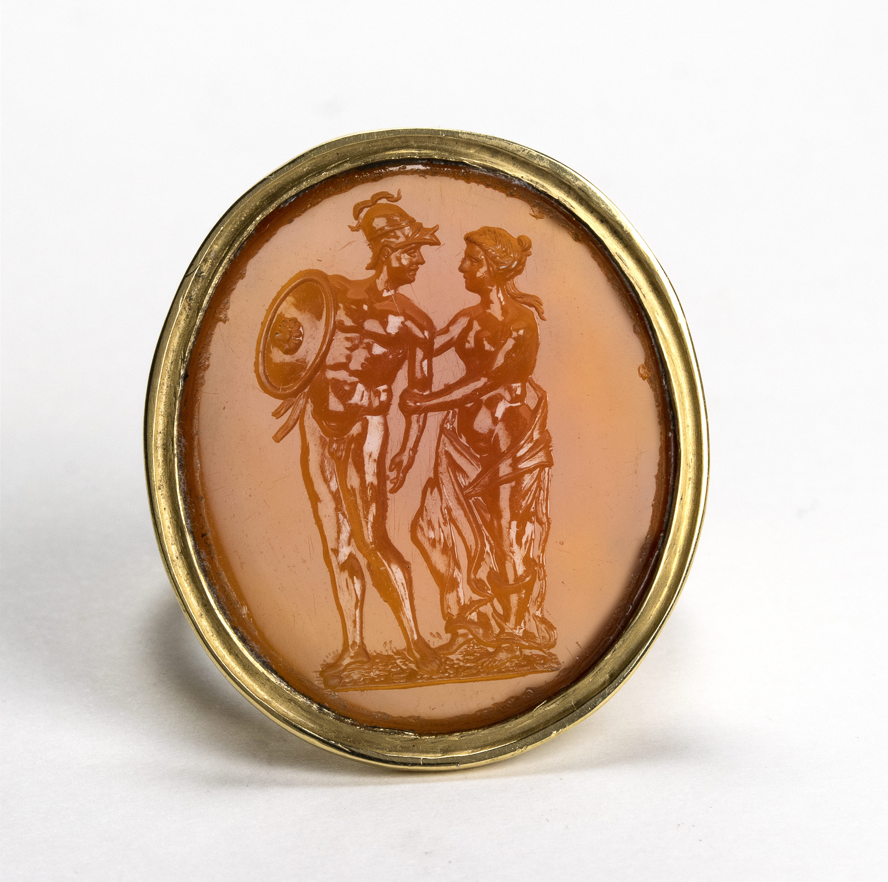 A Large Neoclassical carnelian intaglio set in a later massive gold ring. Mars and Venus.