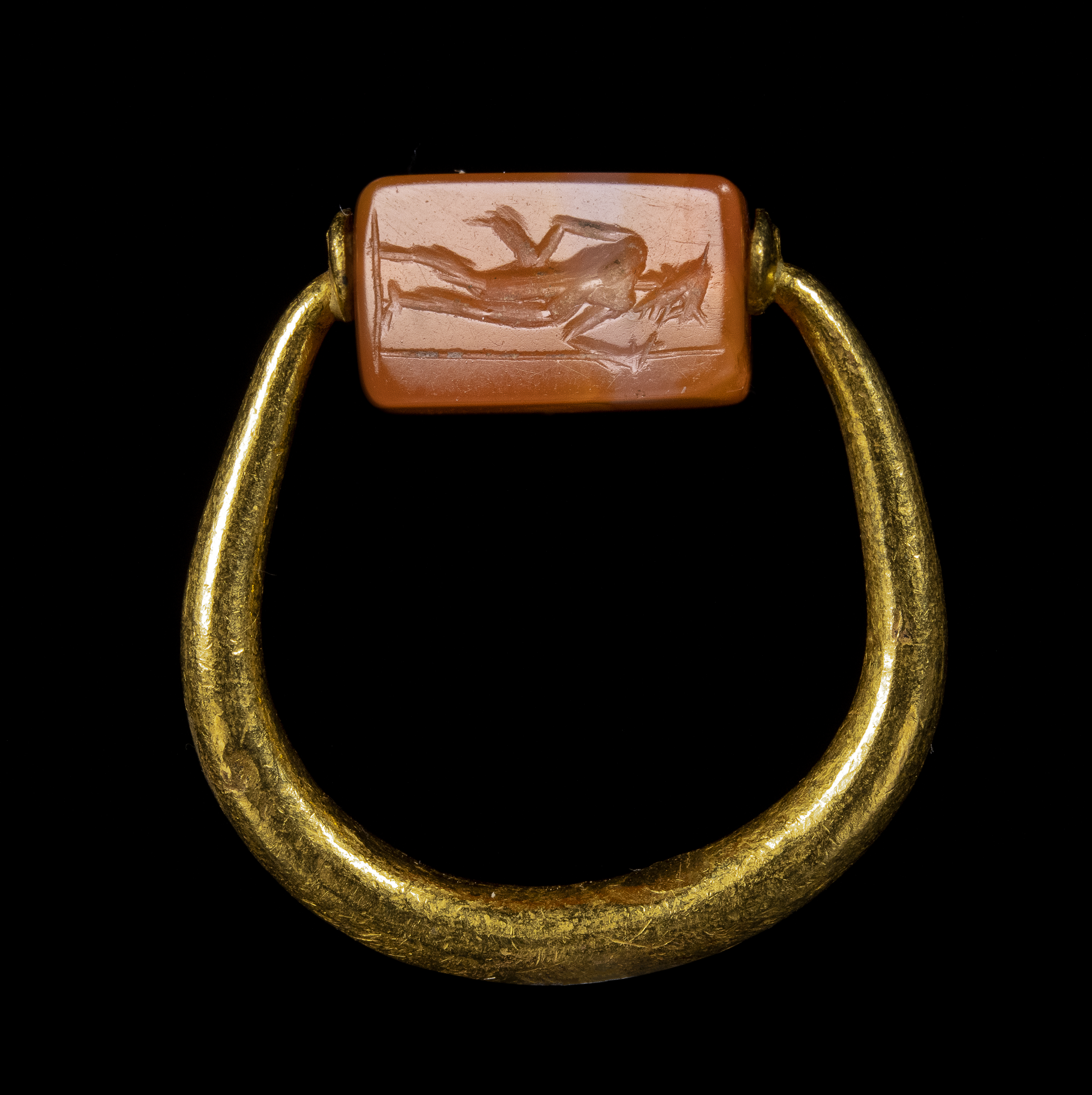 A Graeco-Persian gold swivel ring with a carnelian engraved seal. Mercury and male figure.