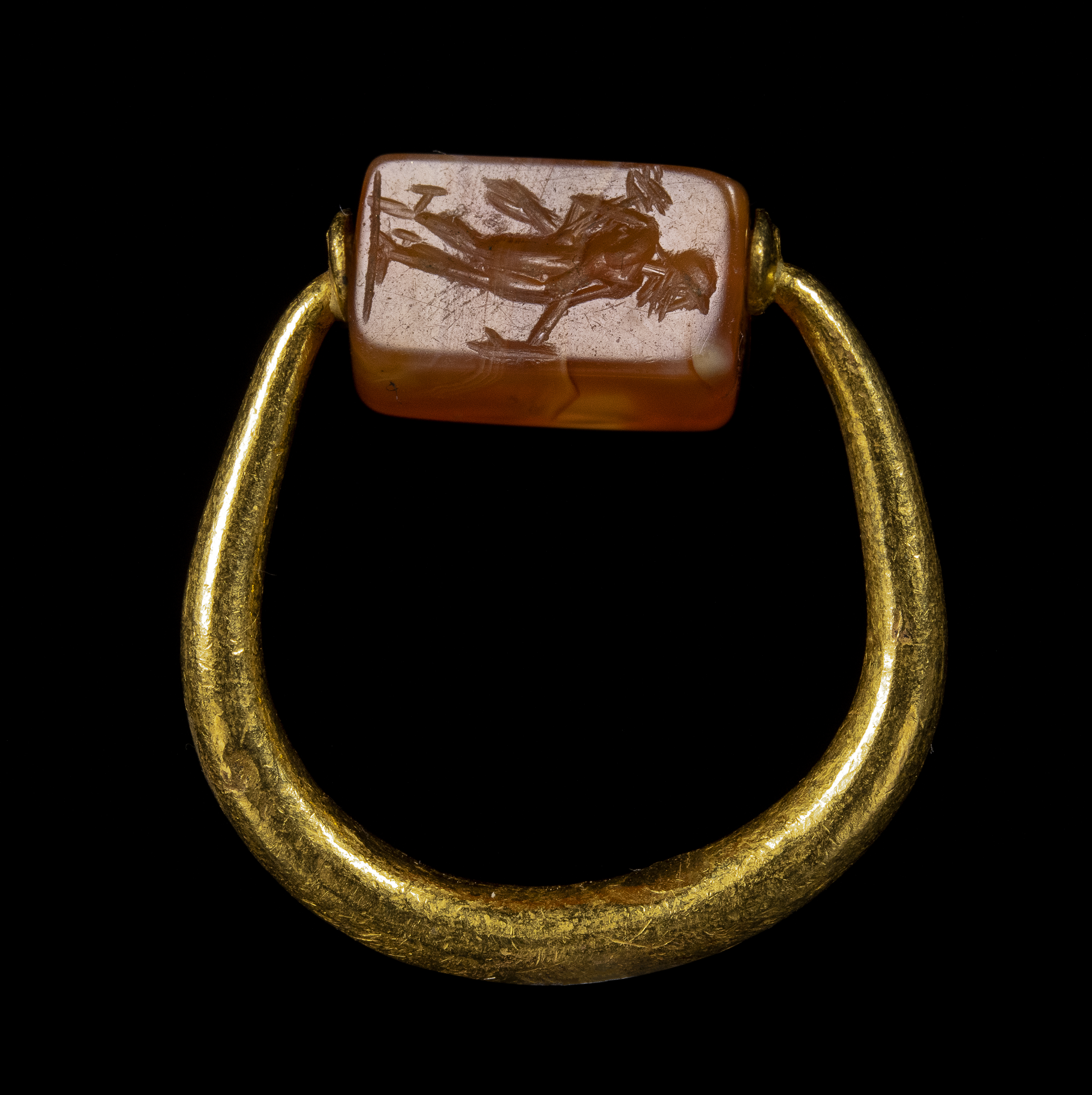 A Graeco-Persian gold swivel ring with a carnelian engraved seal. Mercury and male figure.