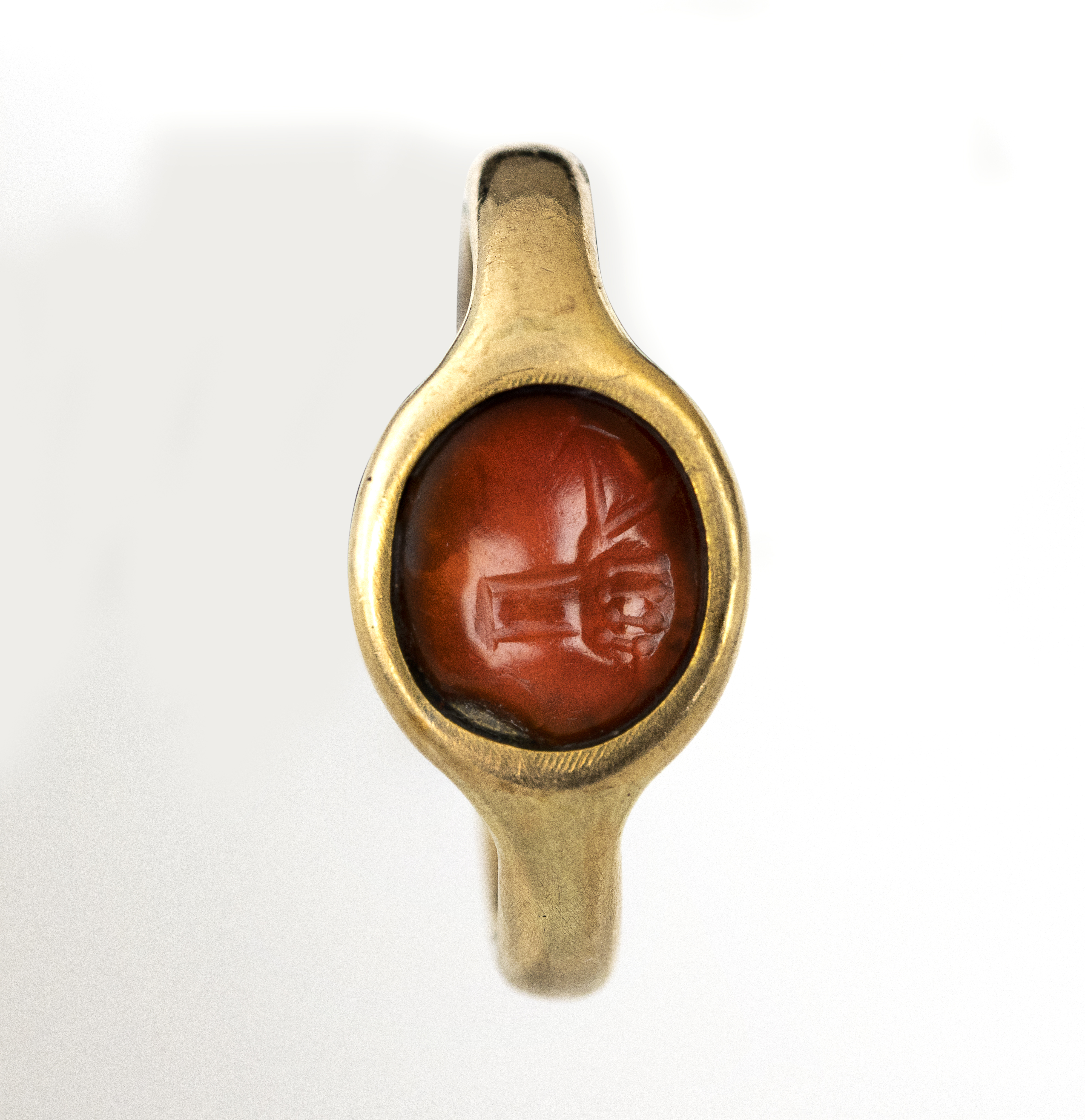 italic, modern, A gold ring set with an Italic carnelian intaglio. Hand with attributes.  (2nd-1st century BCE)