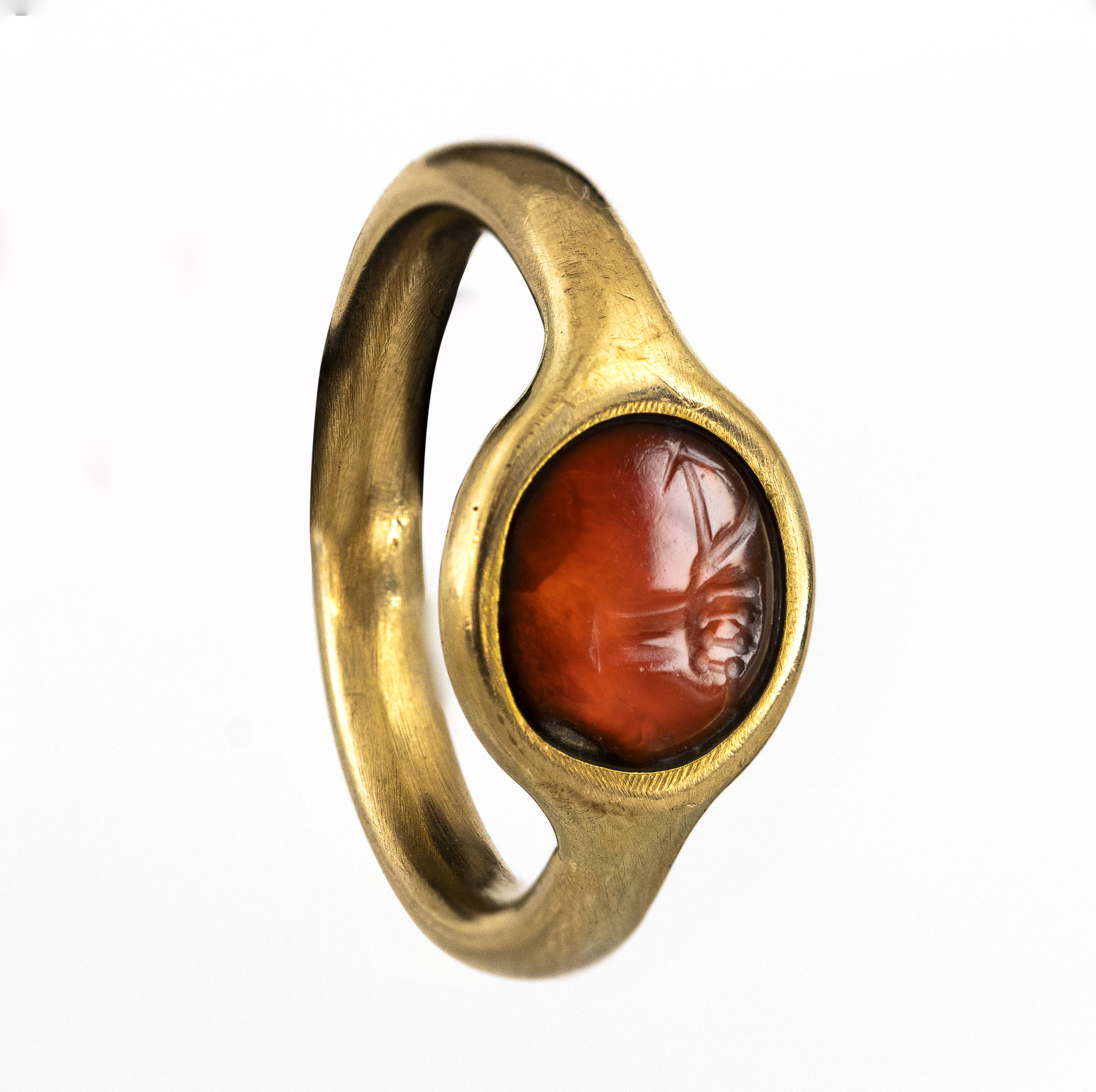 italic, modern, A gold ring set with an Italic carnelian intaglio. Hand with attributes.  (2nd-1st century BCE)