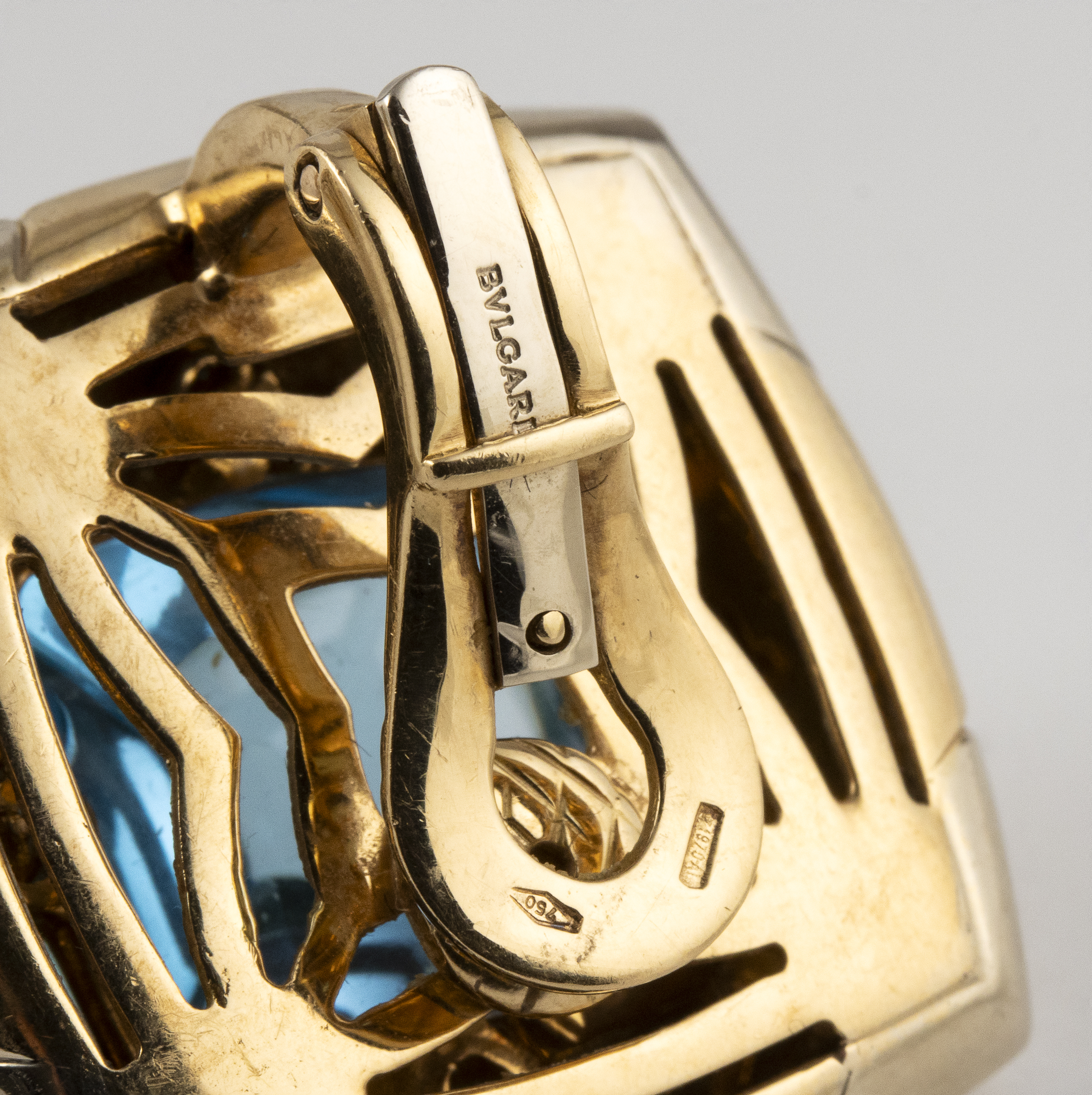 Bulgari. A blue topaz and gold demi-parure— a pair of ear clips and a ring en suite