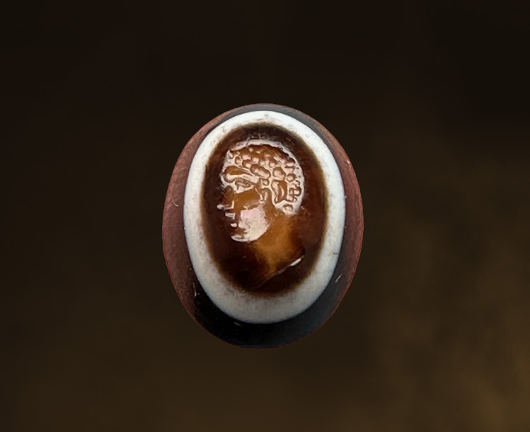 A Roman three-layered agate intaglio. Portrait of young Hercules.