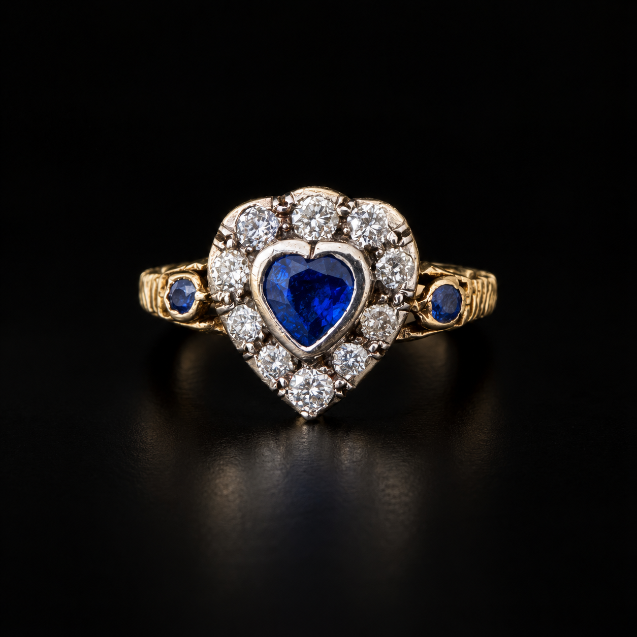A 19th-century heart-shaped sapphire and diamond ring, gold and silver.