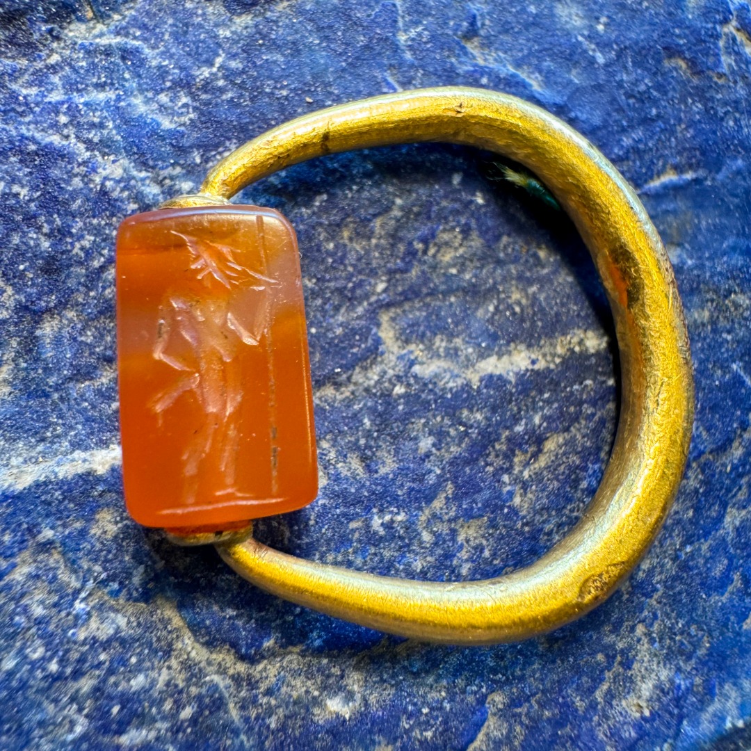 A Graeco-Persian gold swivel ring with a carnelian engraved seal. Mercury and male figure.