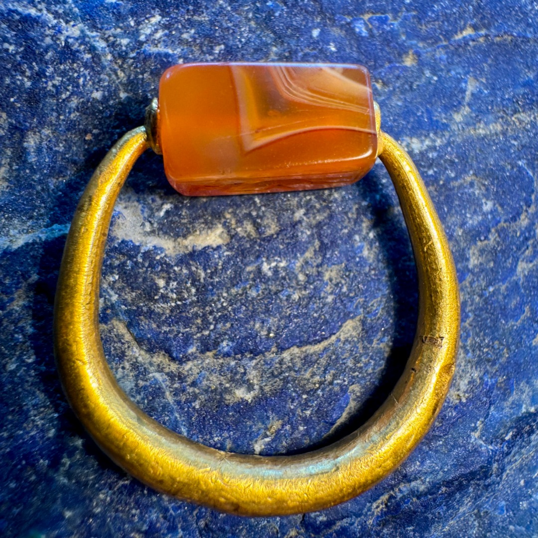 A Graeco-Persian gold swivel ring with a carnelian engraved seal. Mercury and male figure.