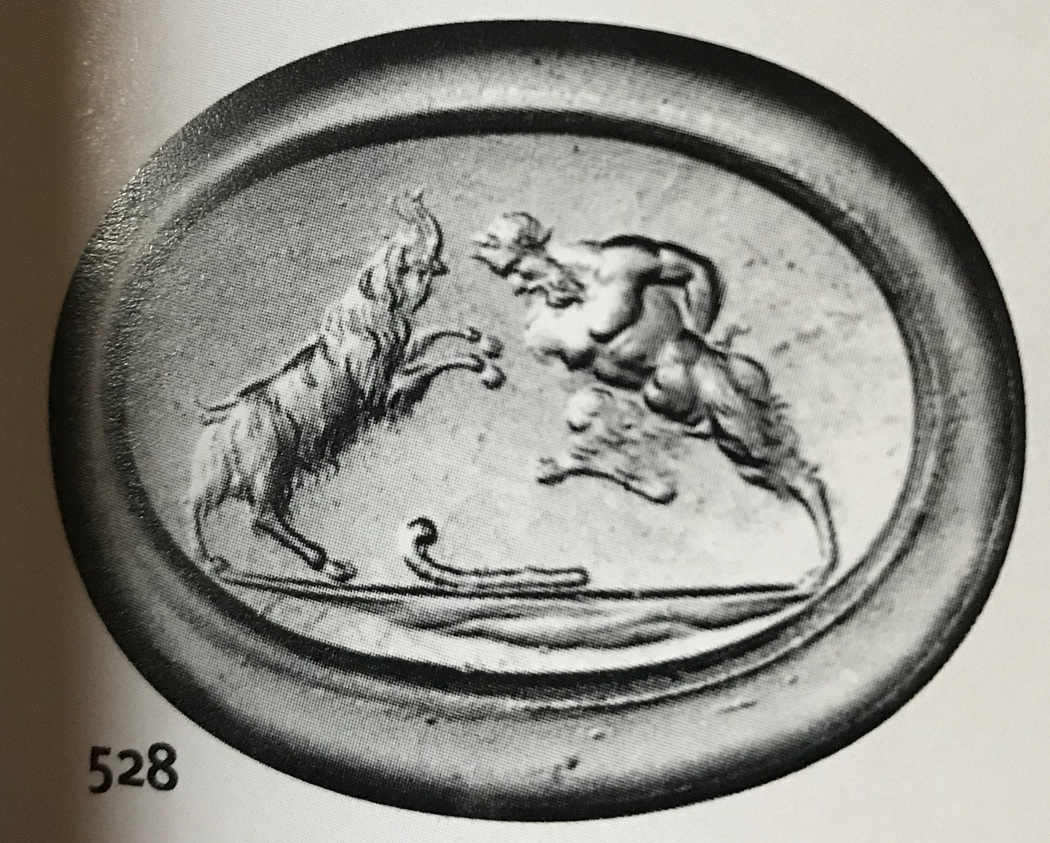 A 18k signet ring set with a Grand Tour carnelian intaglio. Pan fighting a goat. 