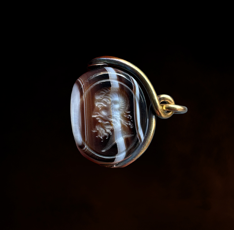 A Victorian banded agate engraved swivel seal with gold mounting. Portrait of Jupiter Ammon
