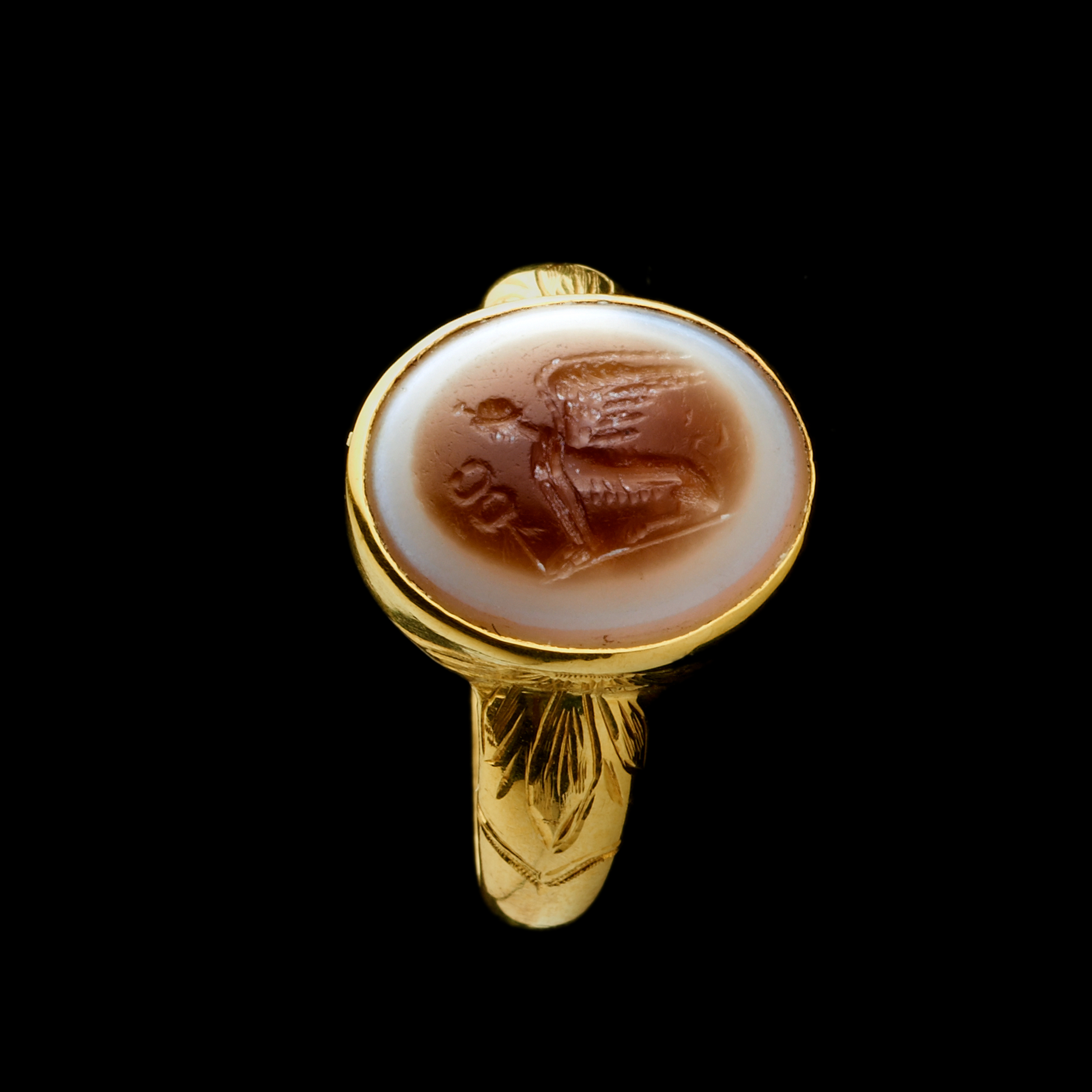 A 19th Century Gold Chiseled Signet Ring set with a Roman Sardonyx Intaglio — Sphinx with Caduceus